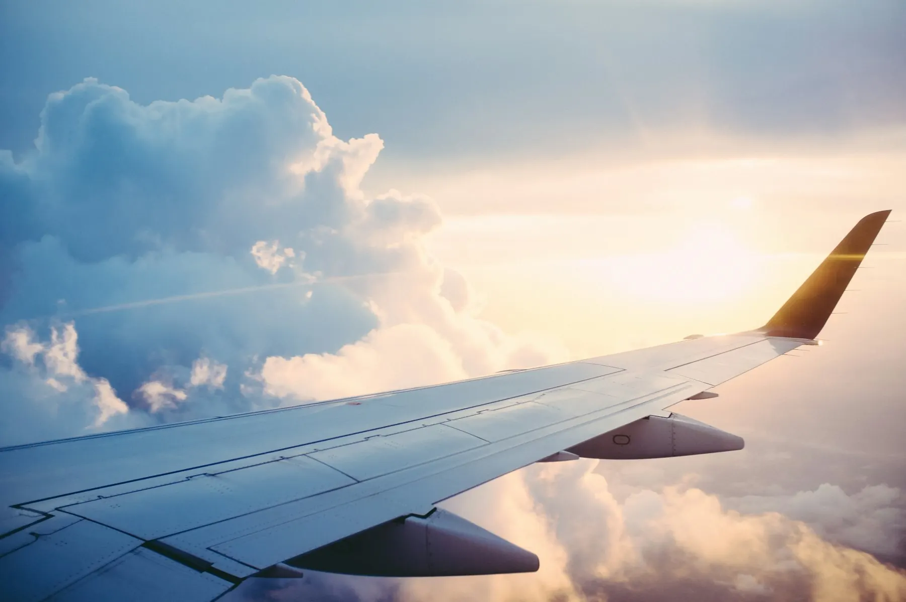 The wing of a plane above the clouds